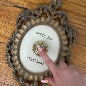 Vintage inspired “press for champagne” wall decor